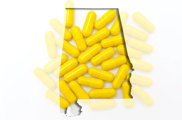 Konturkarta alabama över med transparent piller i bakgrunden — Stockfoto
