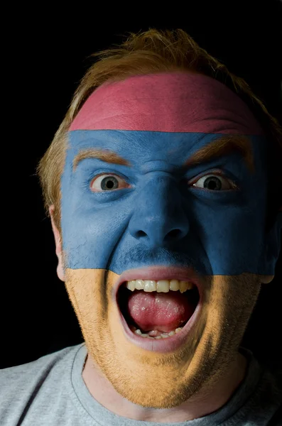 Face of crazy angry man painted in colors of armenia flag — Stock Photo, Image