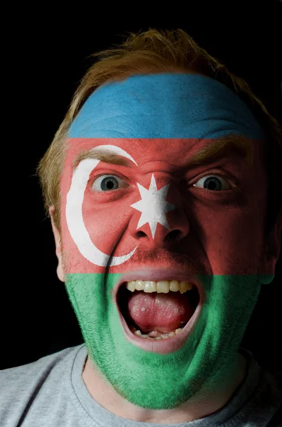 Face of crazy angry man painted in colors of azerbaijan flag — Stock Photo, Image