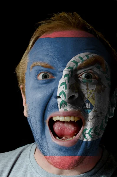 Face of crazy angry man painted in colors of Belize flag — Stock Photo, Image