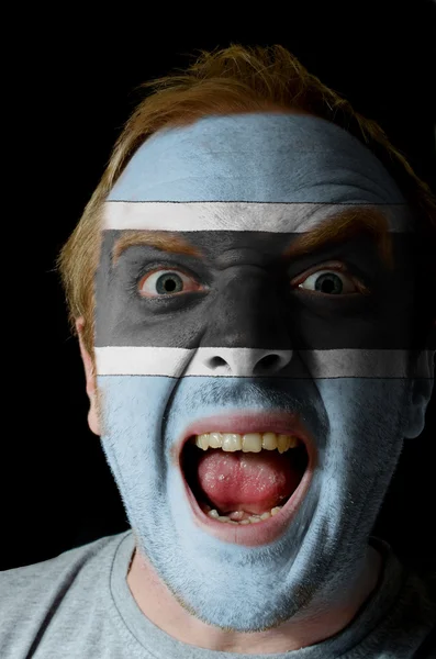 Face of crazy angry man painted in colors of Botswana flag — Stock Photo, Image