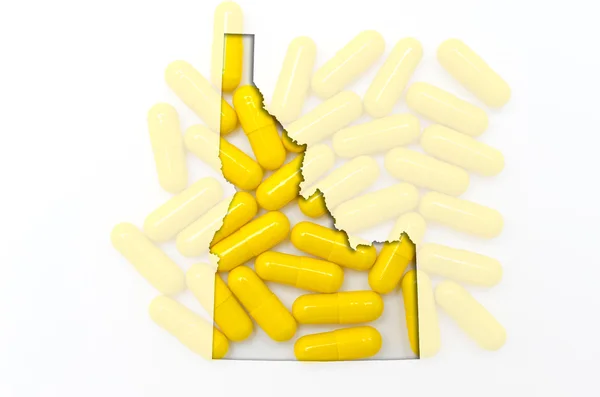 Mappa schematica dell'Idaho con pillole trasparenti sullo sfondo — Foto Stock