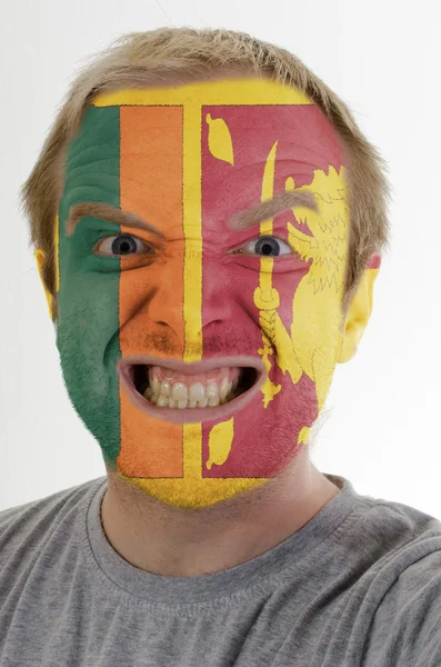 Face of crazy angry man painted in colors of Sri Lanka flag — Stock Photo, Image