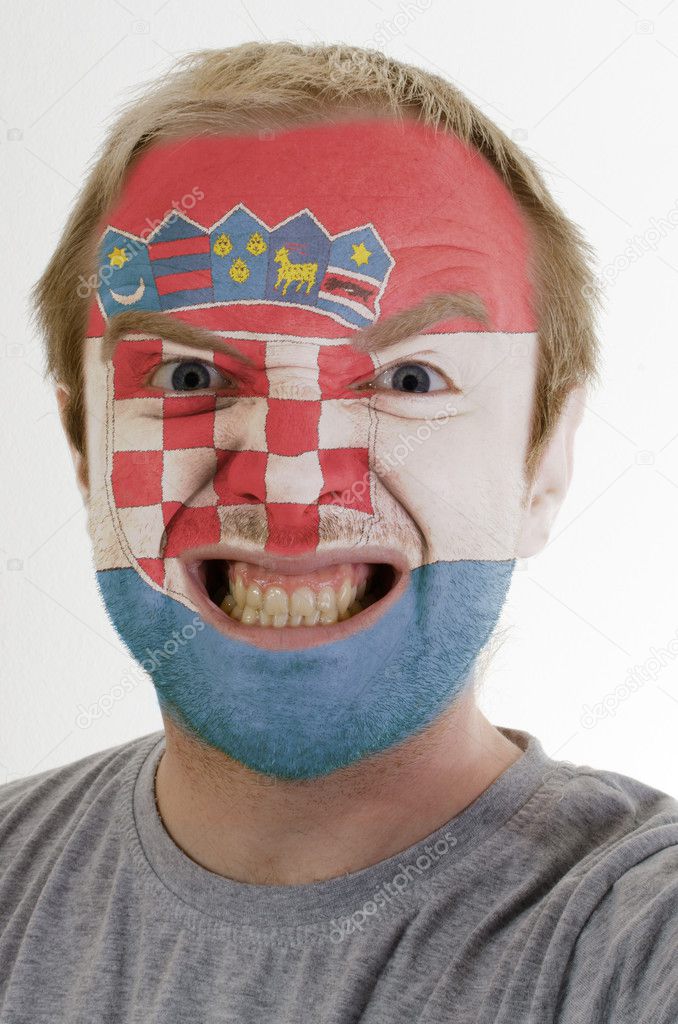 Face of crazy angry man painted in colors of flag
