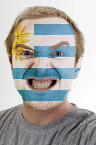 Face of crazy angry man painted in colors of Uruguay flag — Stock Photo, Image