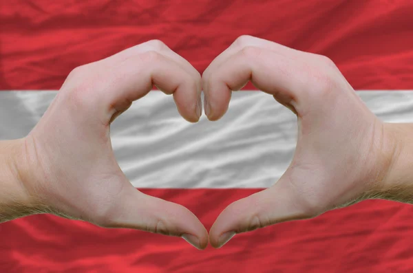 Heart and love gesture showed by hands over flag of Austria back — Stock Photo, Image
