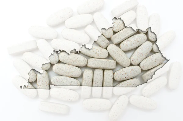 Outline map of Kentucky with transparent pills in the background — Stock Photo, Image