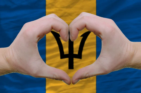 Heart and love gesture showed by hands over flag of barbados bac — Stock Photo, Image