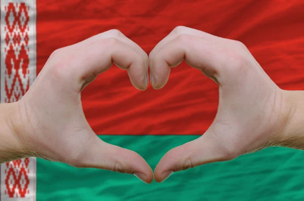 Heart and love gesture showed by hands over flag of belarus back — Stock Photo, Image