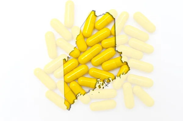 Outline map of maine with transparent pills in the background — Stock Photo, Image