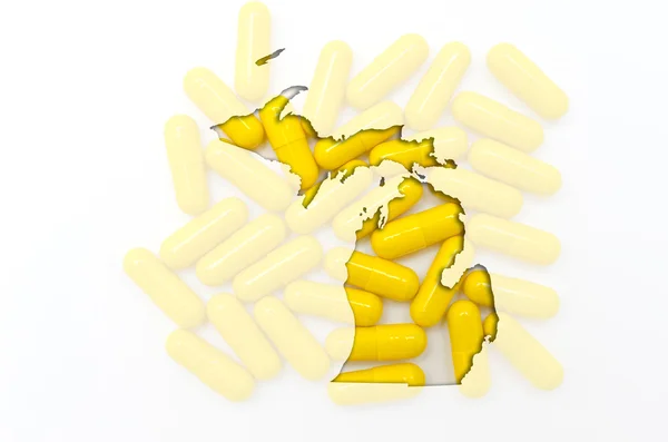 Mapa do contorno de Michigan com pílulas transparentes em segundo plano — Fotografia de Stock