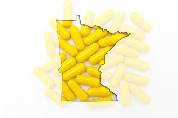 Outline map of minnesota with transparent pills in the backgroun — Stock Photo, Image