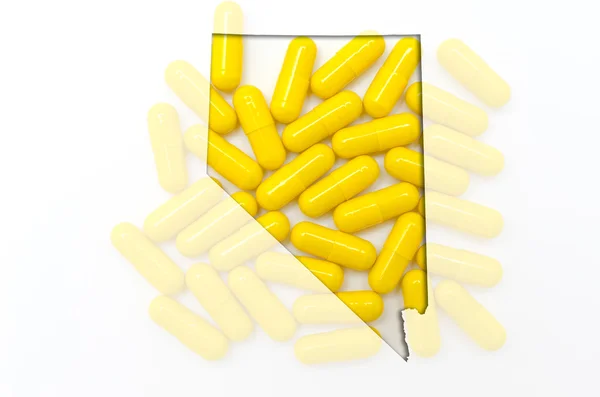 Umrisskarte der Nävada mit transparenten Pillen im Hintergrund — Stockfoto