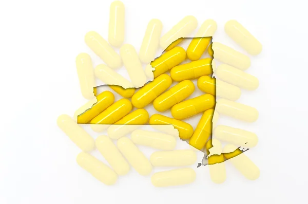 Outline map of new york with transparent pills in the background — Stock Photo, Image