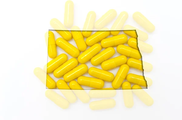 Outline map of north dakota with transparent pills in the backgr — Stock Photo, Image