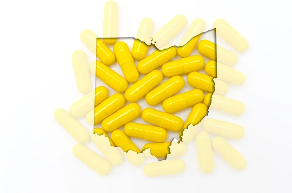 Outline map of ohio with transparent pills in the background — Stock Photo, Image
