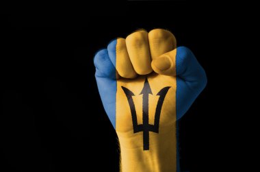 Fist painted in colors of barbados flag clipart