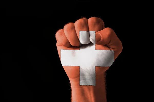 Fist painted in colors of schwitzerland flag — Stock Photo, Image