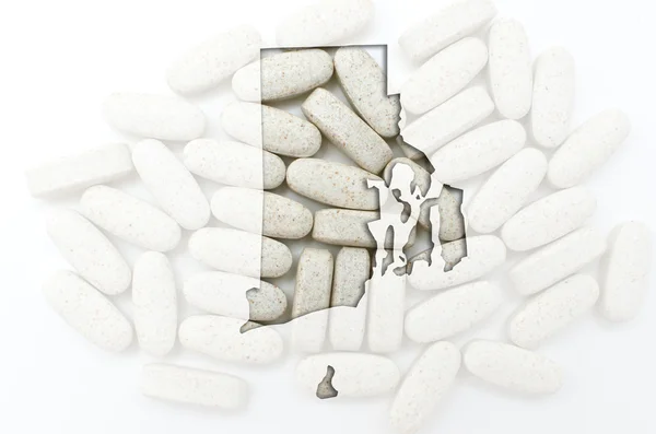 Overzicht van de selecteur van rhode island met transparante pillen in de backgr — Stockfoto