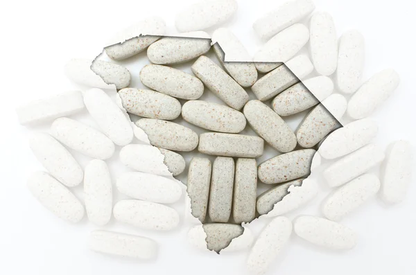 Umrisskarte von South Carolina mit durchsichtigen Pillen im Rücken — Stockfoto