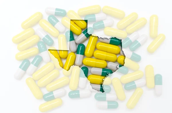 Outline map of texas with transparent pills in the background — Stock Photo, Image