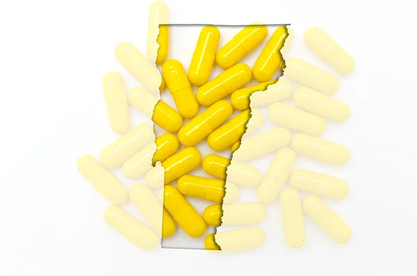 Outline map of vermont with transparent pills in the background — Stock Photo, Image