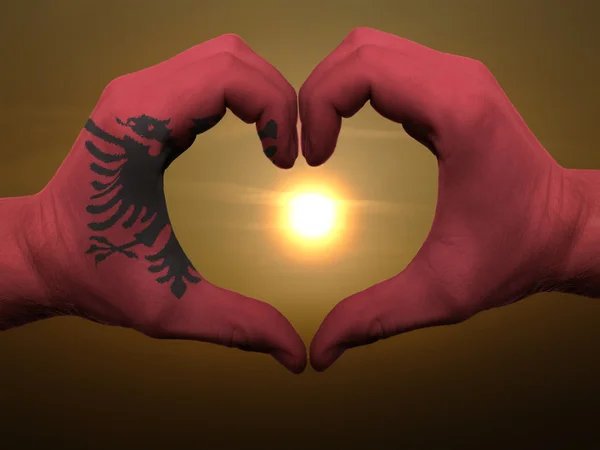 Heart and love gesture by hands colored in albania flag during b — Stock Photo, Image