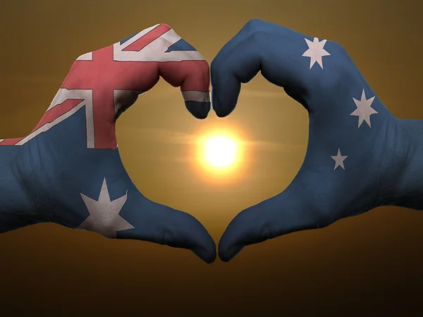 Heart and love gesture by hands colored in australia flag during — Stock Photo, Image