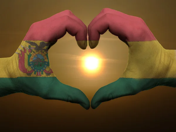 Coração e amor gesto por mãos coloridas na bandeira da bolívia durante b — Fotografia de Stock