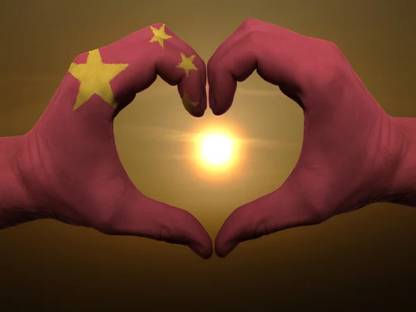 Жест любви и сердца руками, раскрашенными в фарфоровый флаг во время бобы — стоковое фото