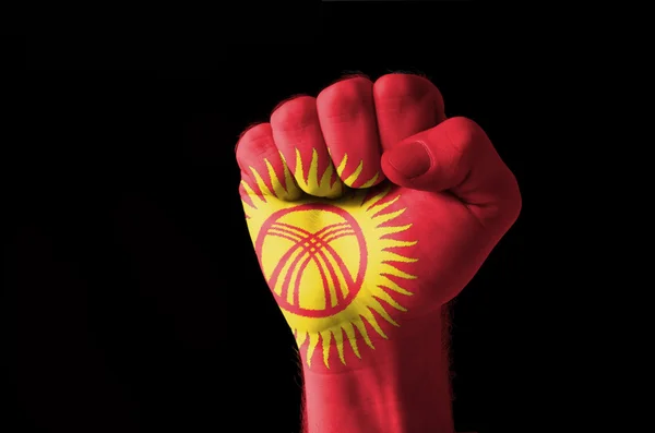 Fist painted in colors of kyrghyzstan flag — Stock Photo, Image