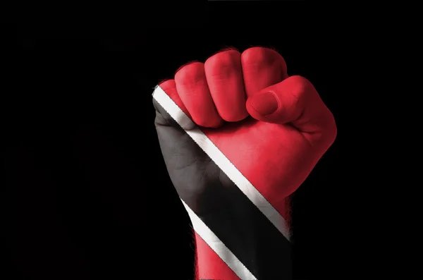 Кулак, окрашенный в цвета флага табаго Тринидада — стоковое фото