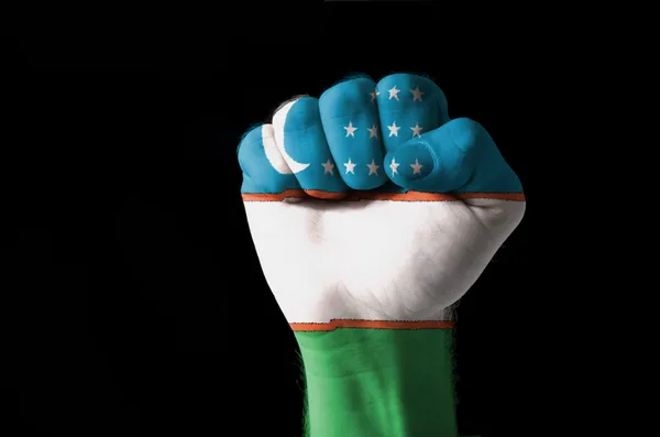 Fist painted in colors of uzbekistan flag — Stock Photo, Image