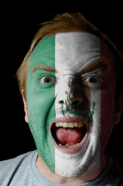 Face of crazy angry man painted in colors of mexico flag clipart