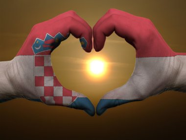 Heart and love gesture by hands colored in croatia flag during b clipart