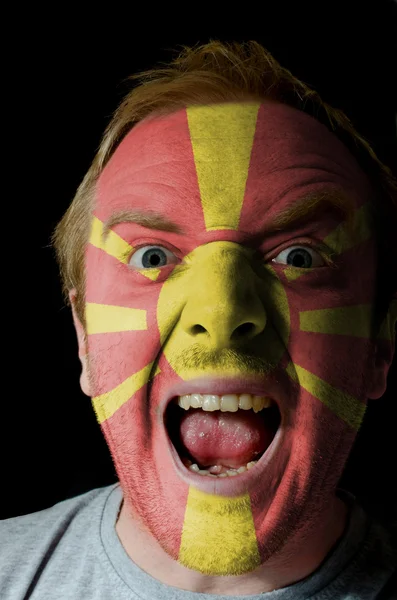 stock image Face of crazy angry man painted in colors of macedonia flag