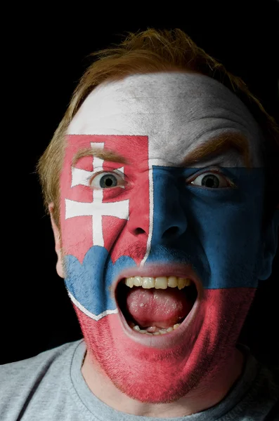 Face of crazy angry man painted in colors of slovakia flag — Stock Photo, Image