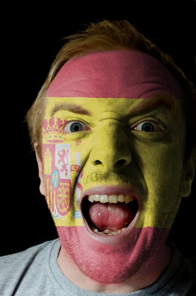 Őrült dühös ember arca festett Spanyolország lobogója — Stock Fotó