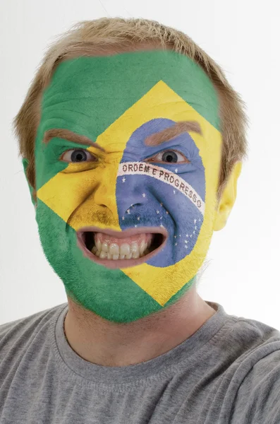 stock image Face of crazy angry man painted in colors of brazil flag