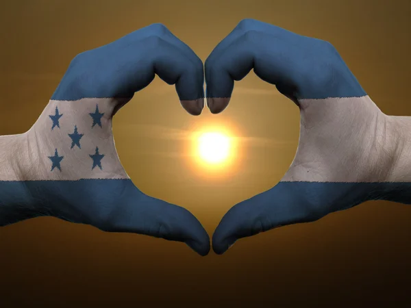 Stock image Heart and love gesture by hands colored in honduras flag during