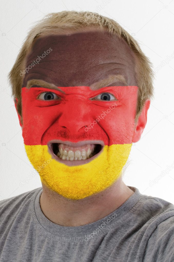 Face of crazy angry man painted in colors of german flag