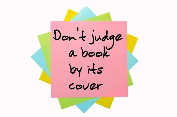 Proverb "Don't judge a book by its cover" written on bunch o — Stock Photo, Image