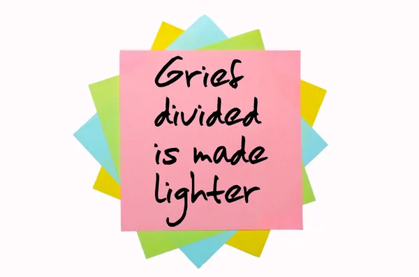 Proverb " Grief divided is made lighter " written on bunch of — Stock Photo, Image