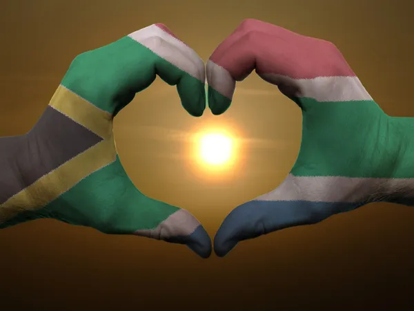 Heart and love gesture by hands colored in south africa flag dur — Stock Photo, Image