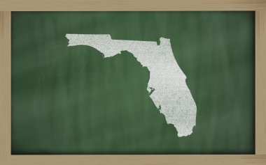 Outline map of florida on blackboard clipart