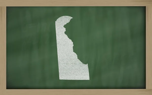 stock image Outline map of delaware on blackboard