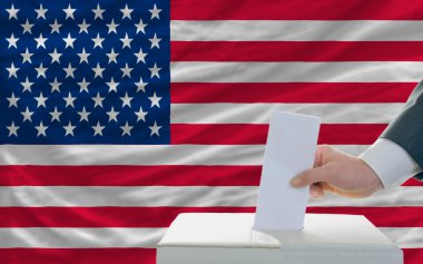 Man voting on elections in america in front of flag clipart