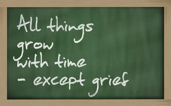 " All things grow with time - except grief " written on a blackb — Stock Photo, Image