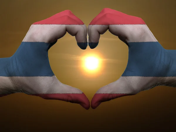 Heart and love gesture by hands colored in thailand flag during — Stock Photo, Image