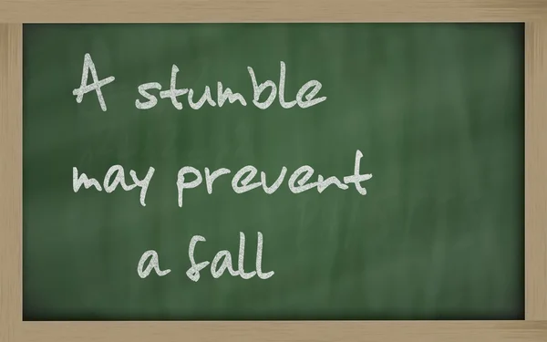 " A stumble may prevent a fall " written on a blackboard — Stock Photo, Image